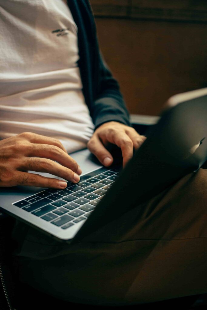 Developer typing on a laptop while working on a Kohana migration to PHP 8